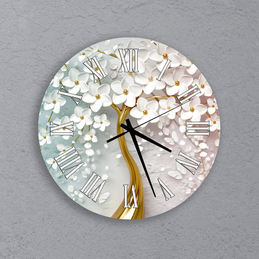 A round wall clock with a white flower design and gold accents.