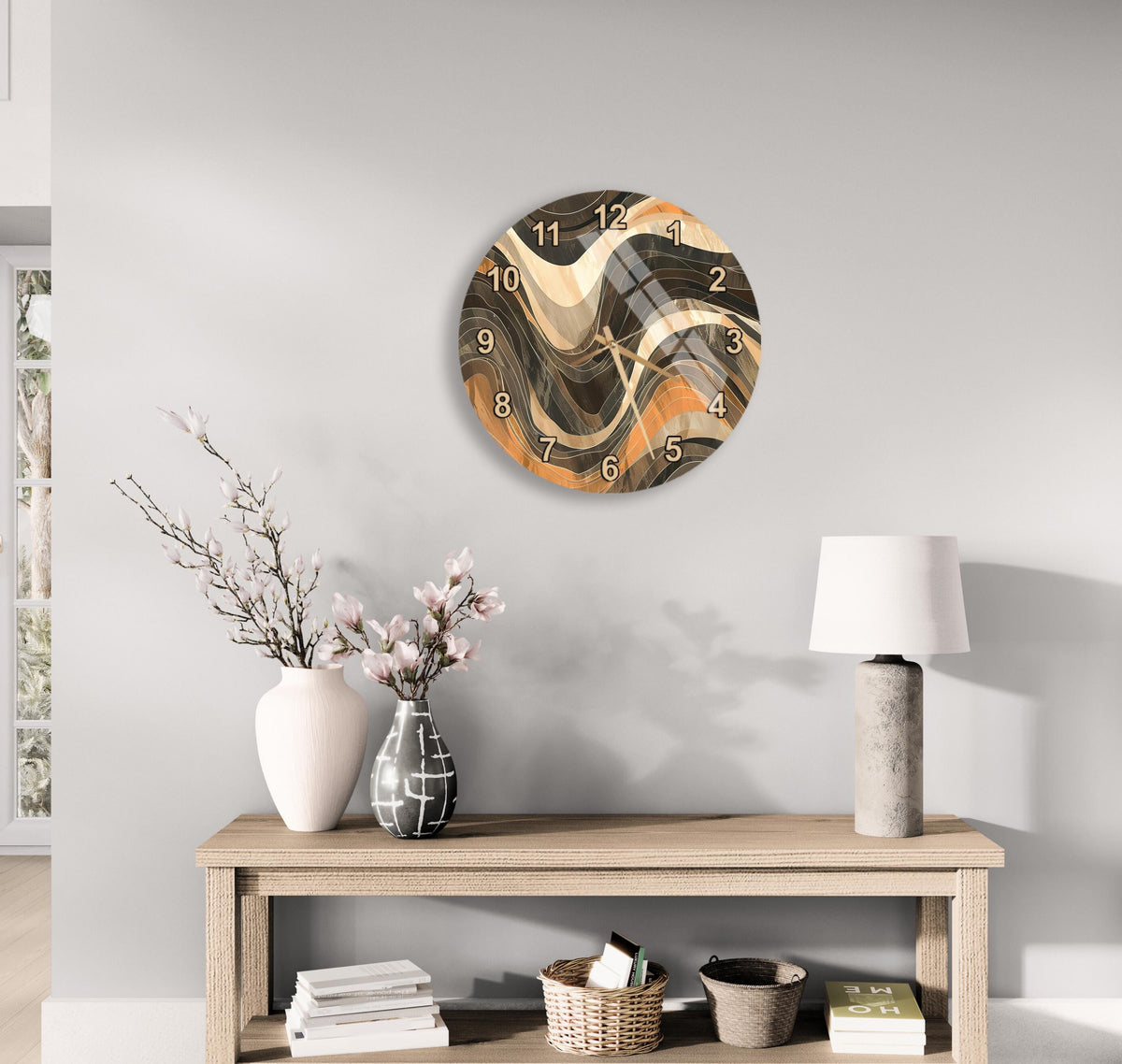 a modern living room with a wooden console table, a round wall clock with a unique abstract design, a lamp, a vase with flowers, and some books.