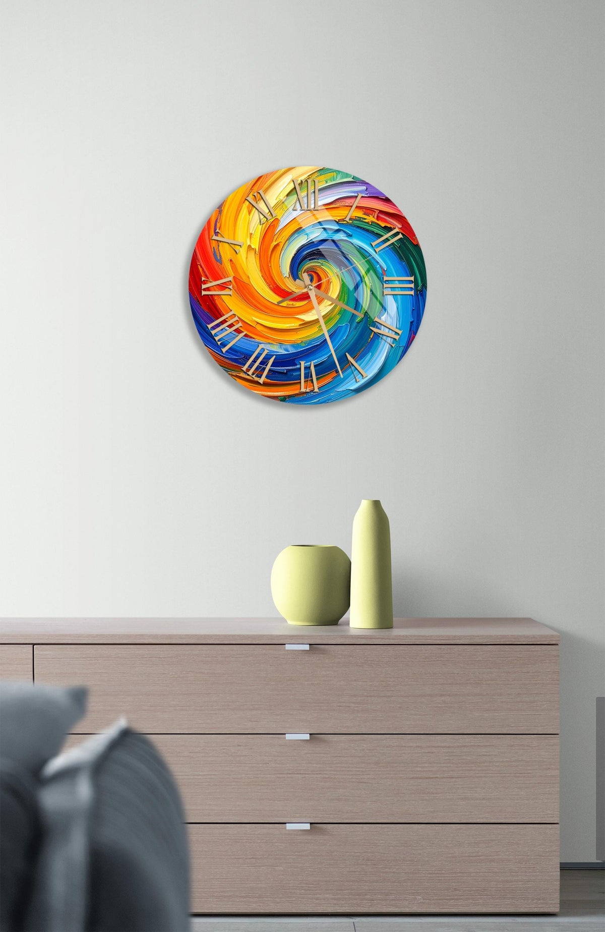 a vibrant, abstract clock design with swirling colors and patterns, mounted on a wall above a wooden dresser.