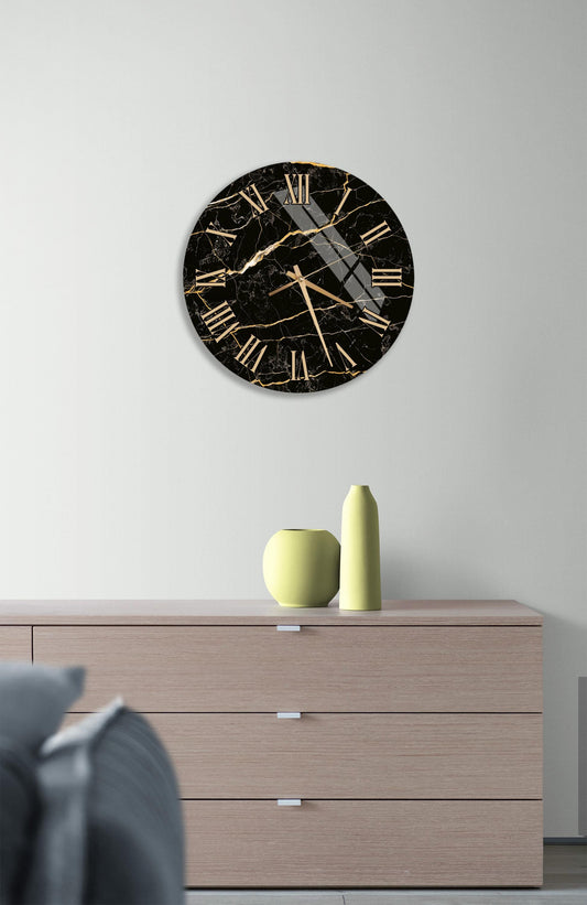 a modern black and gold clock mounted on a white wall above a wooden dresser with three drawers.