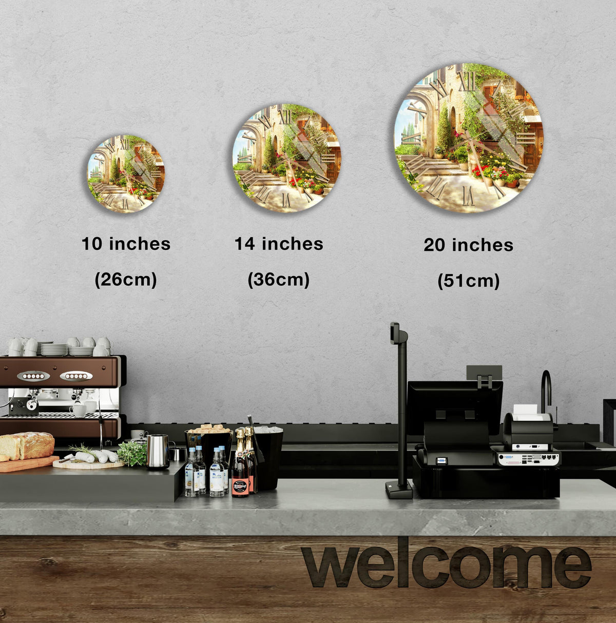 a counter with a cash register, a coffee machine, and various food items such as bottles and bread. Above the counter, there are three clock-like images of different sizes, indicating the time in inches. The counter also has a "welcome" sign, suggesting a welcoming atmosphere in the space.