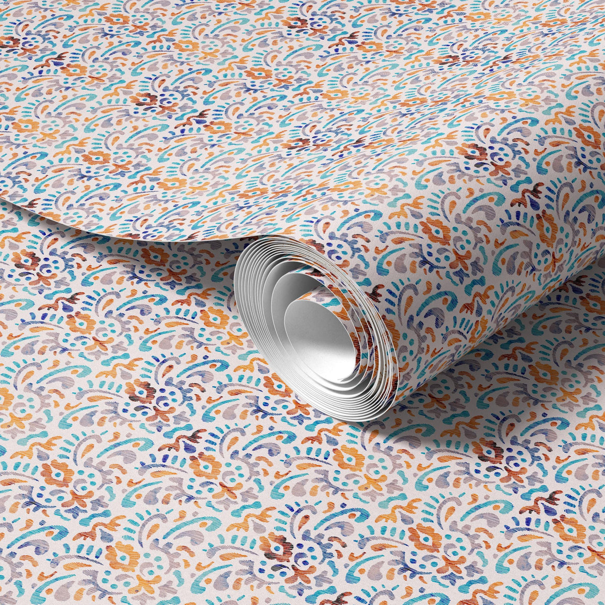 a roll of patterned wallpaper or paper with a repeating floral or paisley design in various shades of blue, orange, and green.
