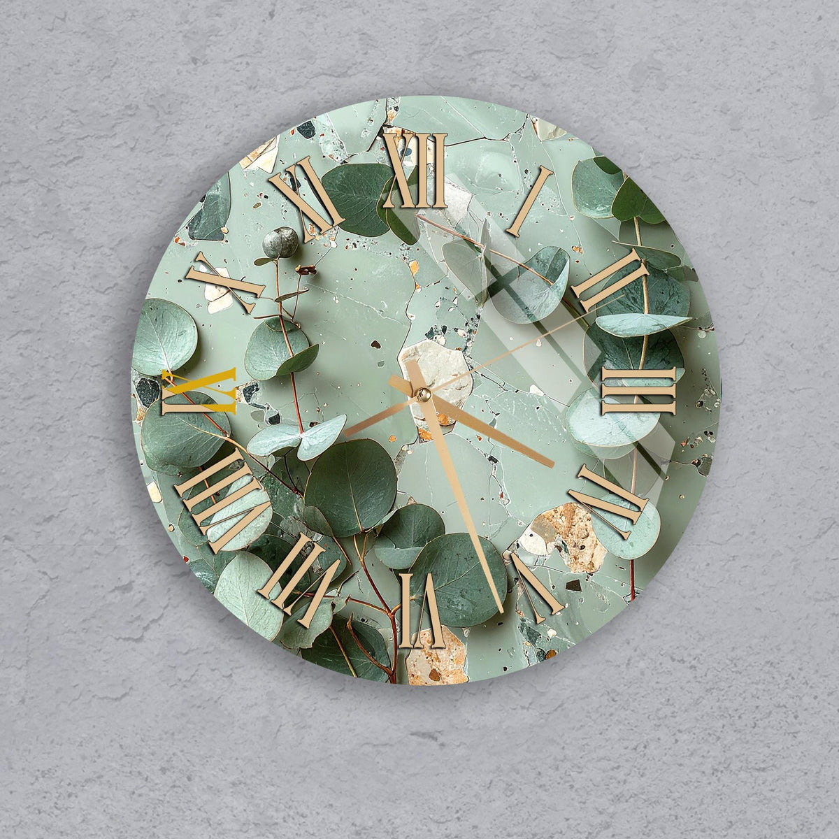 A wall clock with a green leafy background and gold Roman numerals.