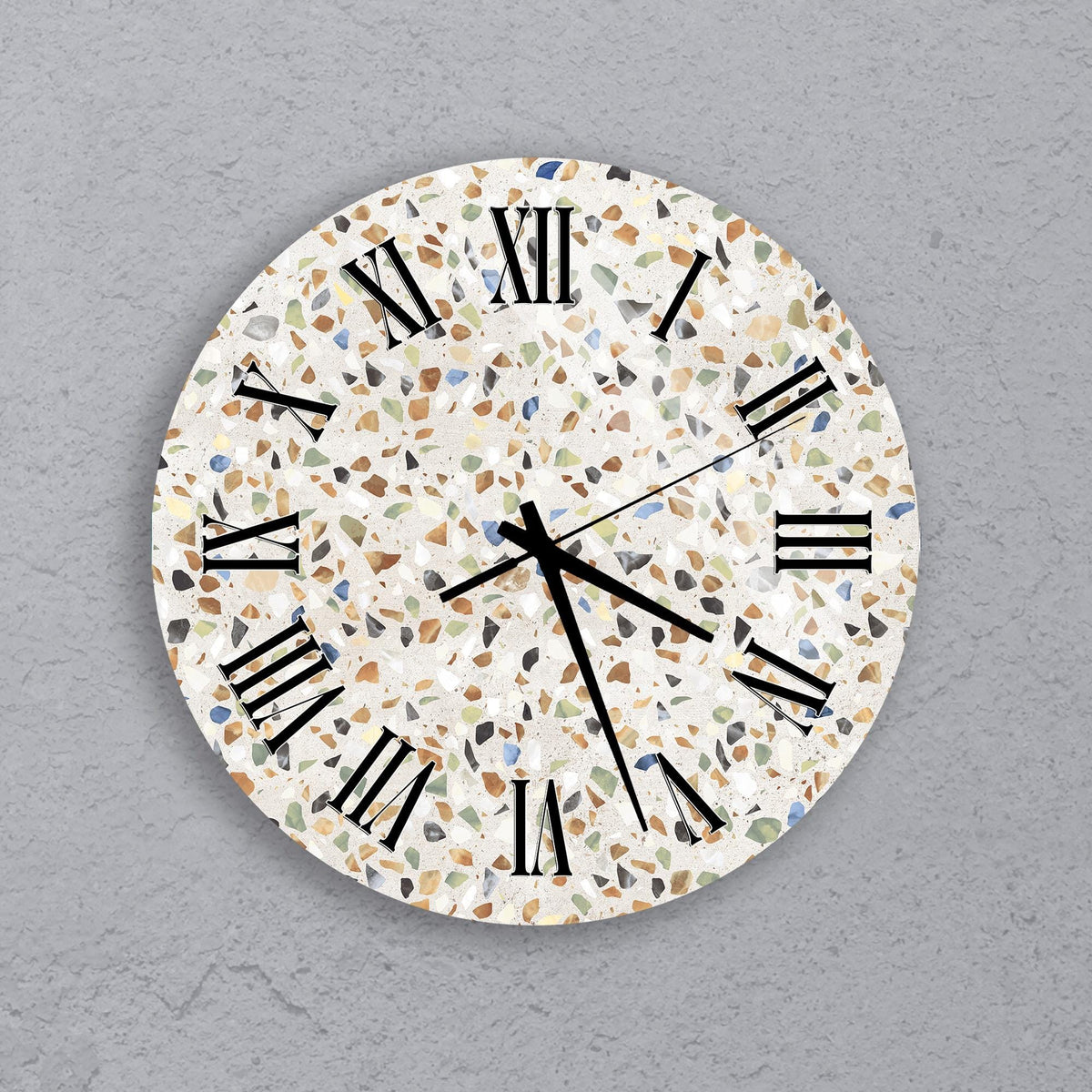 A round wall clock with a mosaic pattern on its face, displaying the time as approximately 10:10.