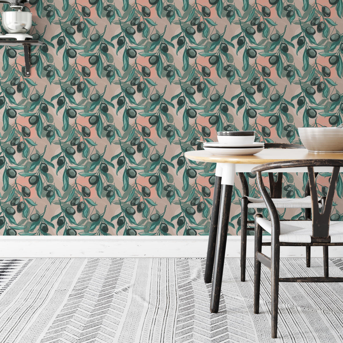 a dining area with a table and chairs, set against a wall with a vibrant, repeating pattern of green leaves and orange fruit. The table is set with plates and bowls, creating a cozy and inviting atmosphere.