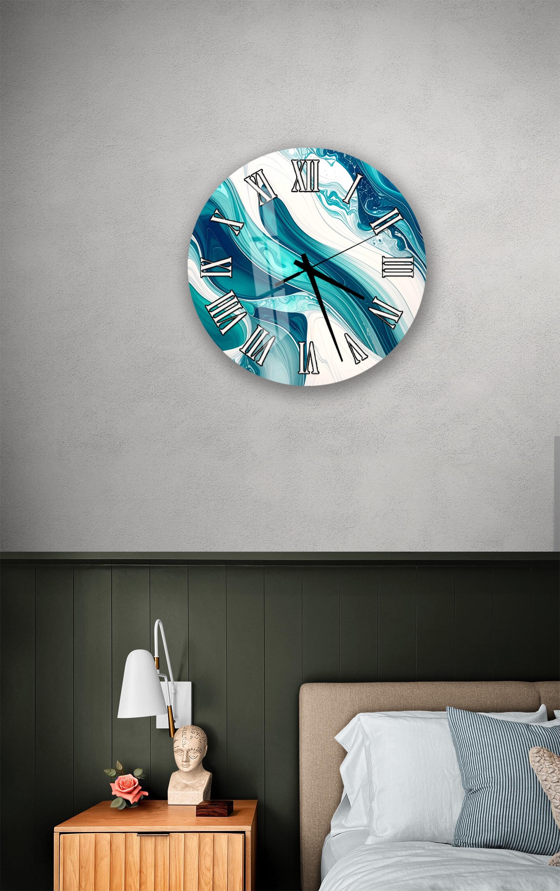 a bedroom setting with a round wall clock displaying a blue and white design, a wooden nightstand with a lamp, and a bed with white sheets and pillows.