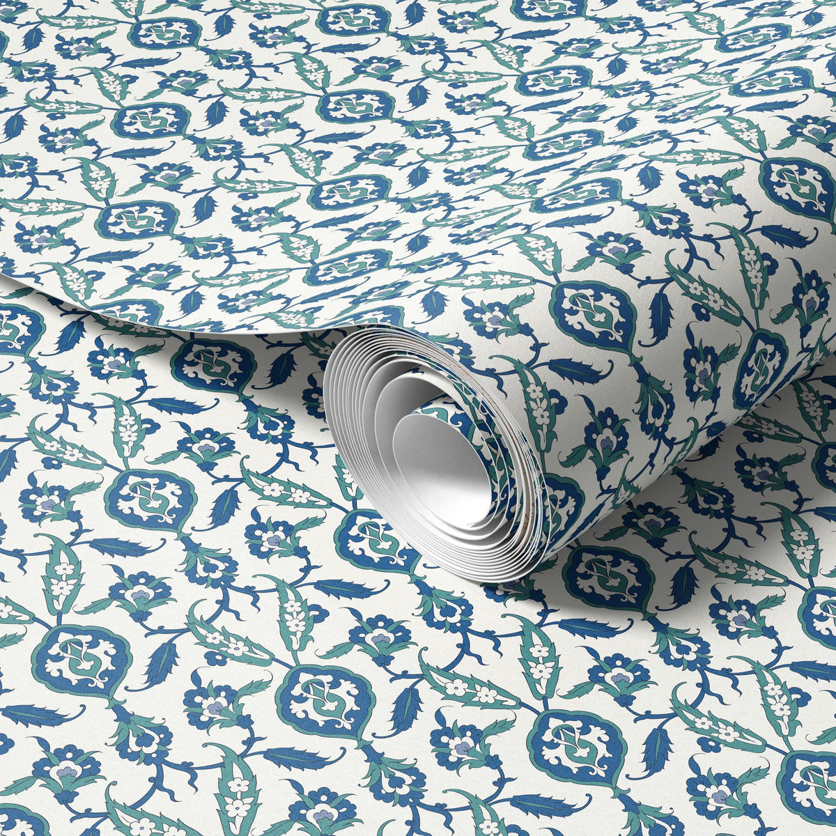 a roll of wallpaper with a repeating pattern of blue and white floral designs.