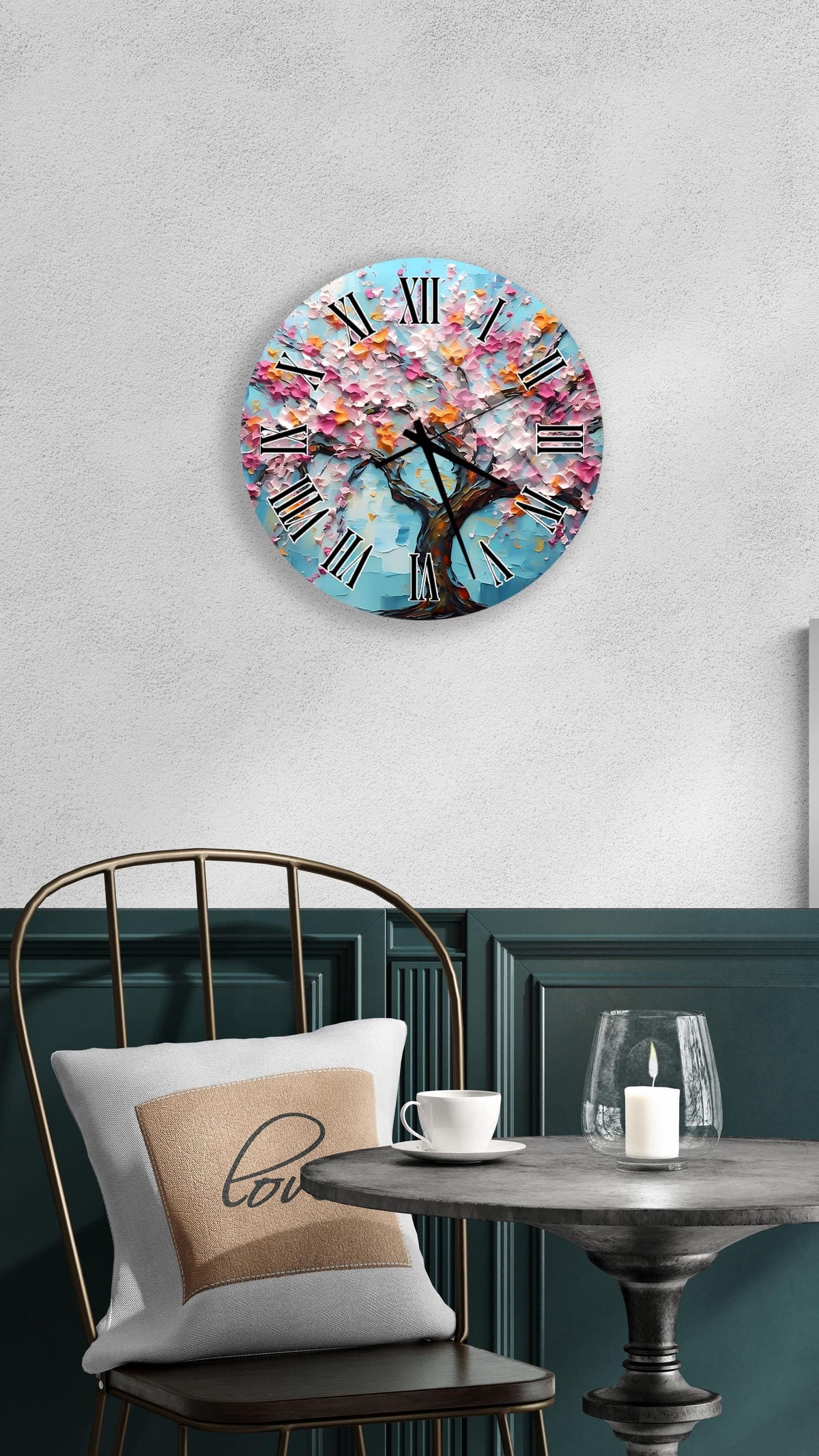 a round wall clock with a tree design, mounted on a wall above a table with a white tablecloth.