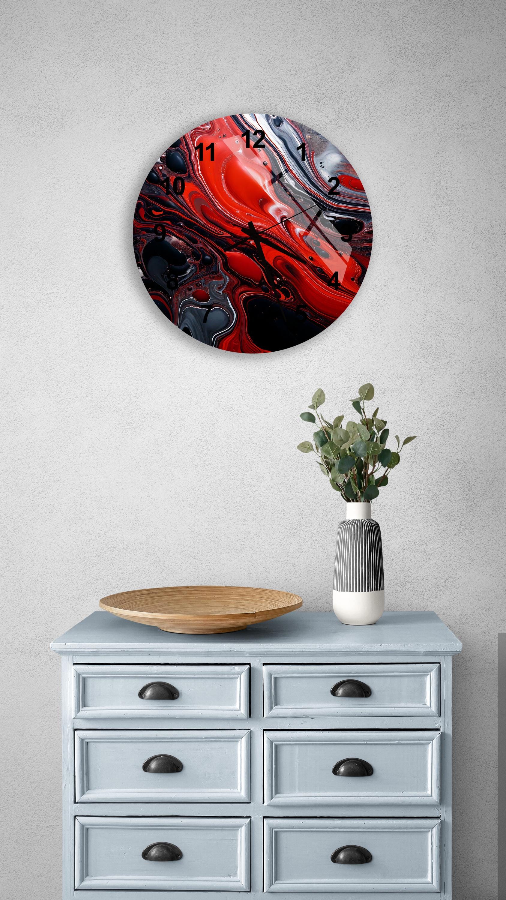 a blue dresser with a vase of flowers on top of it