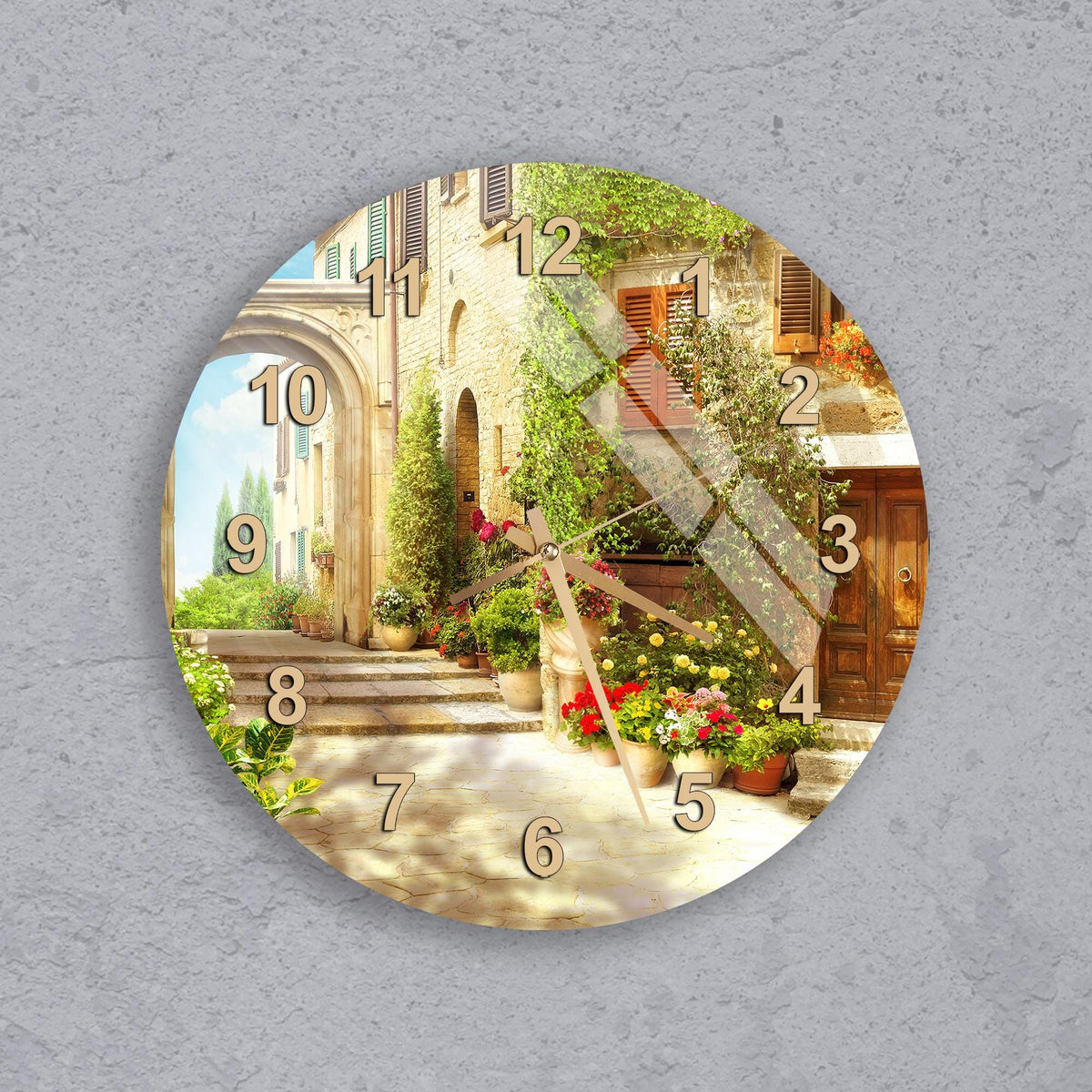 A wall clock with a scenic outdoor view of a building, plants, and steps.