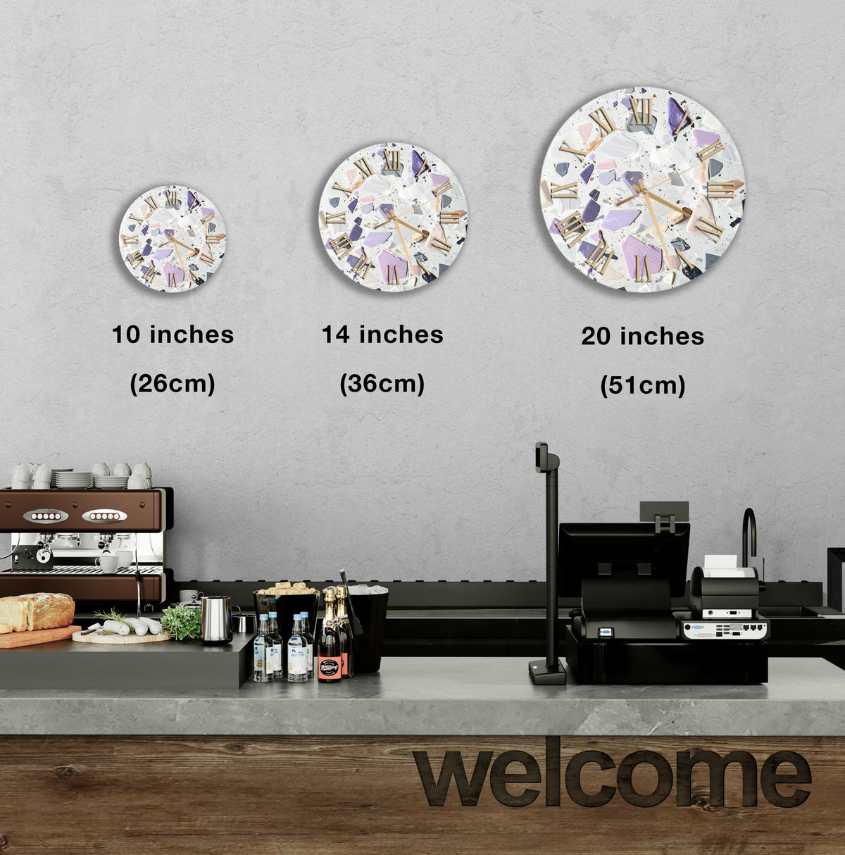 a counter with a cash register, a coffee machine, and a display of various items such as bottles and a sandwich. Above the counter, there are three clock faces of different sizes, each with a different design. The image also includes text indicating the sizes of the clock faces in inches.