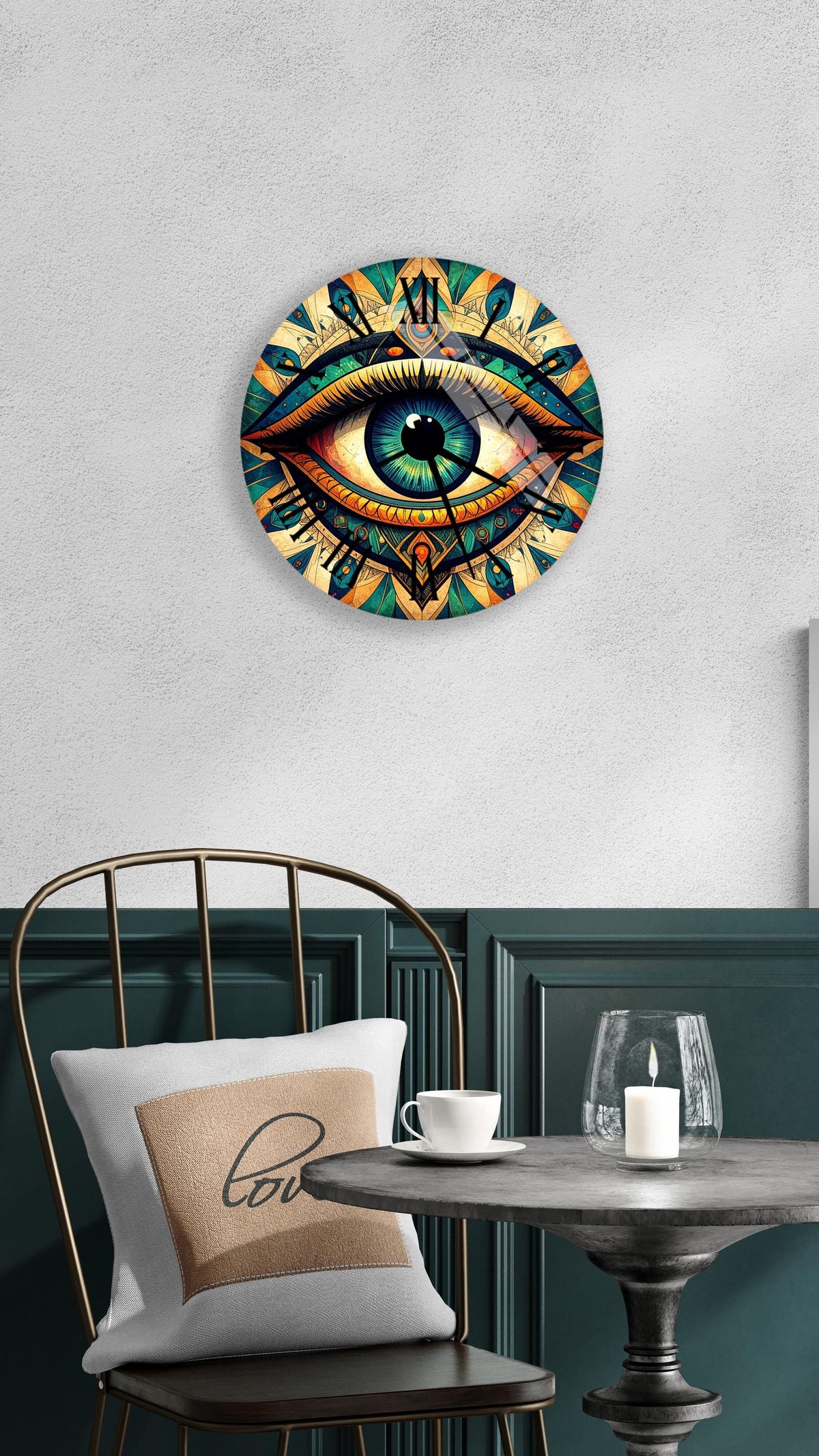 a wall clock with a large eye design, a white pillow with the word "love" on it, a small table with a candle and a glass, and a black metal chair.