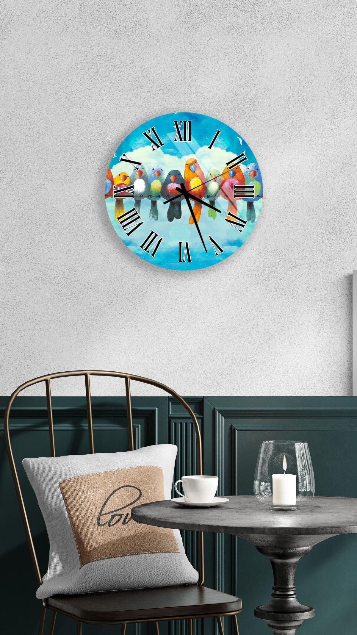 a clock with a bird design on it, mounted on a wall above a table with a white tablecloth.