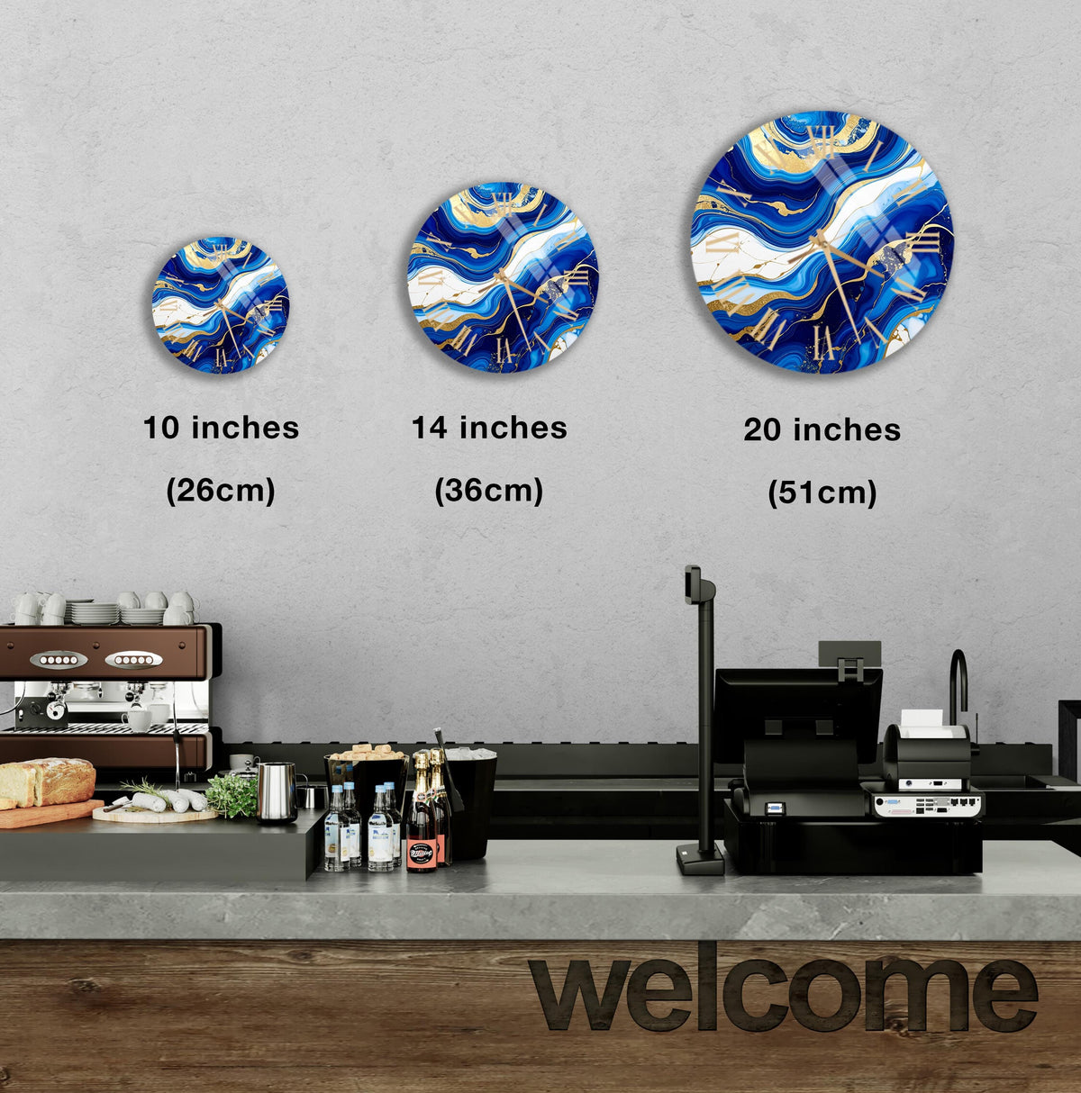 a counter in a restaurant with a "welcome" sign, and three round wall decals of varying sizes above the counter.