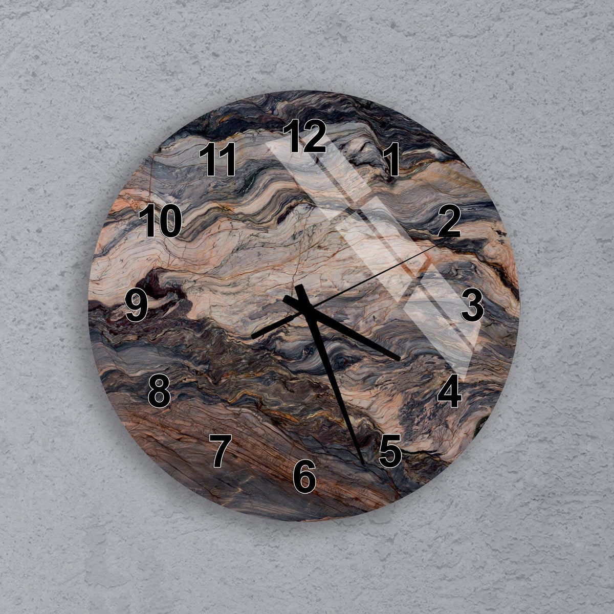 A round wall clock with a marble-like design on its face.