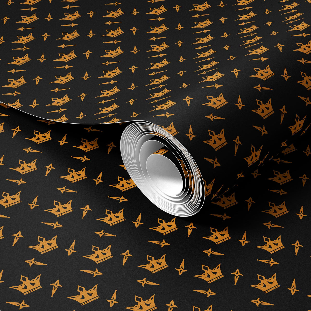 a roll of paper with a repeating pattern of gold crowns on a black background.