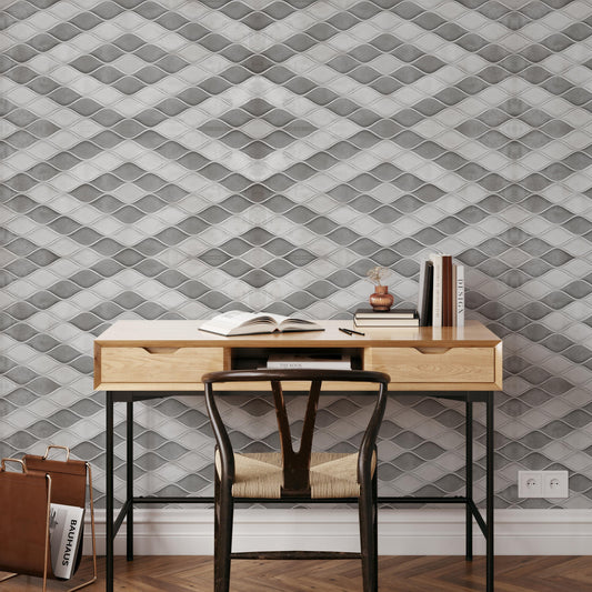 a modern workspace with a wooden desk, a black chair, and a bookshelf against a textured gray and white wall.