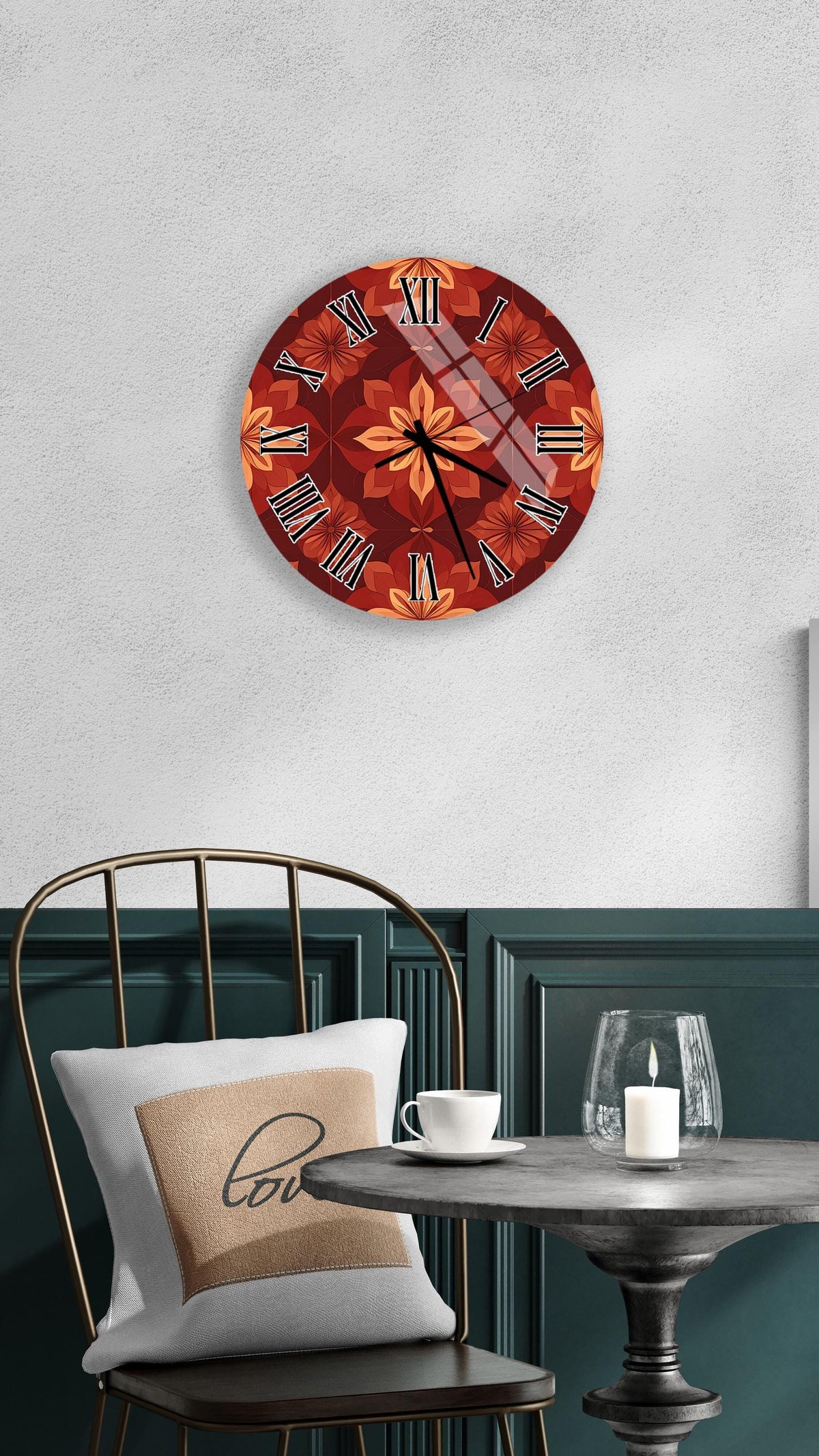 a wall clock with a floral design, a white table with a candle and a cup, and a green chair with a pillow.
