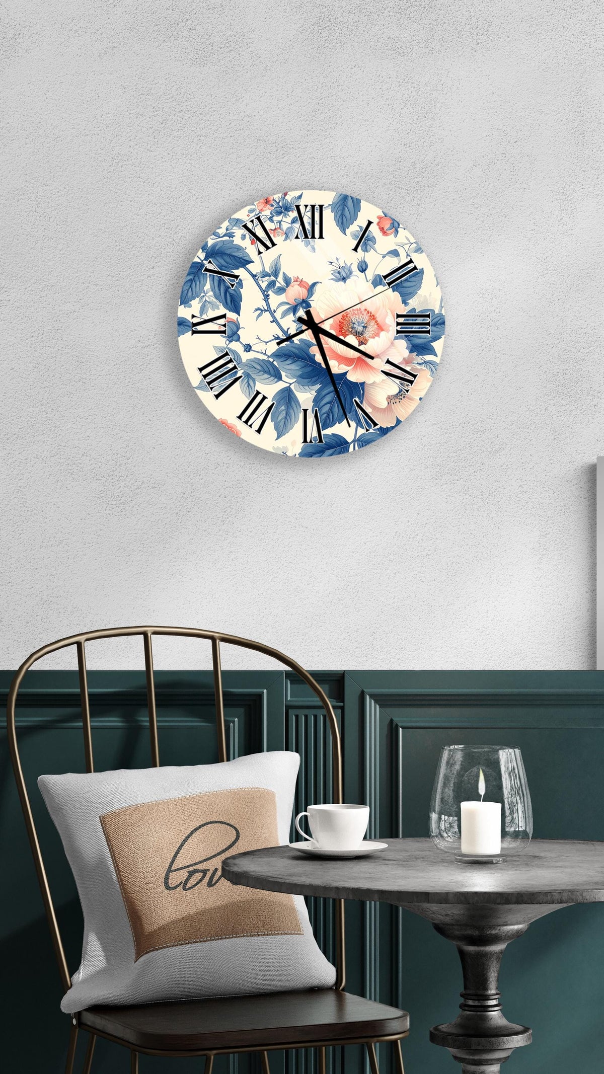 a wall clock with a floral design, a table with a white cup and a candle, and a chair with a pillow.