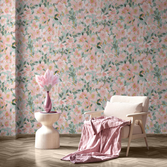 a cozy living room with a floral wallpaper, a white armchair, and a small side table with a pink vase and a pink blanket.