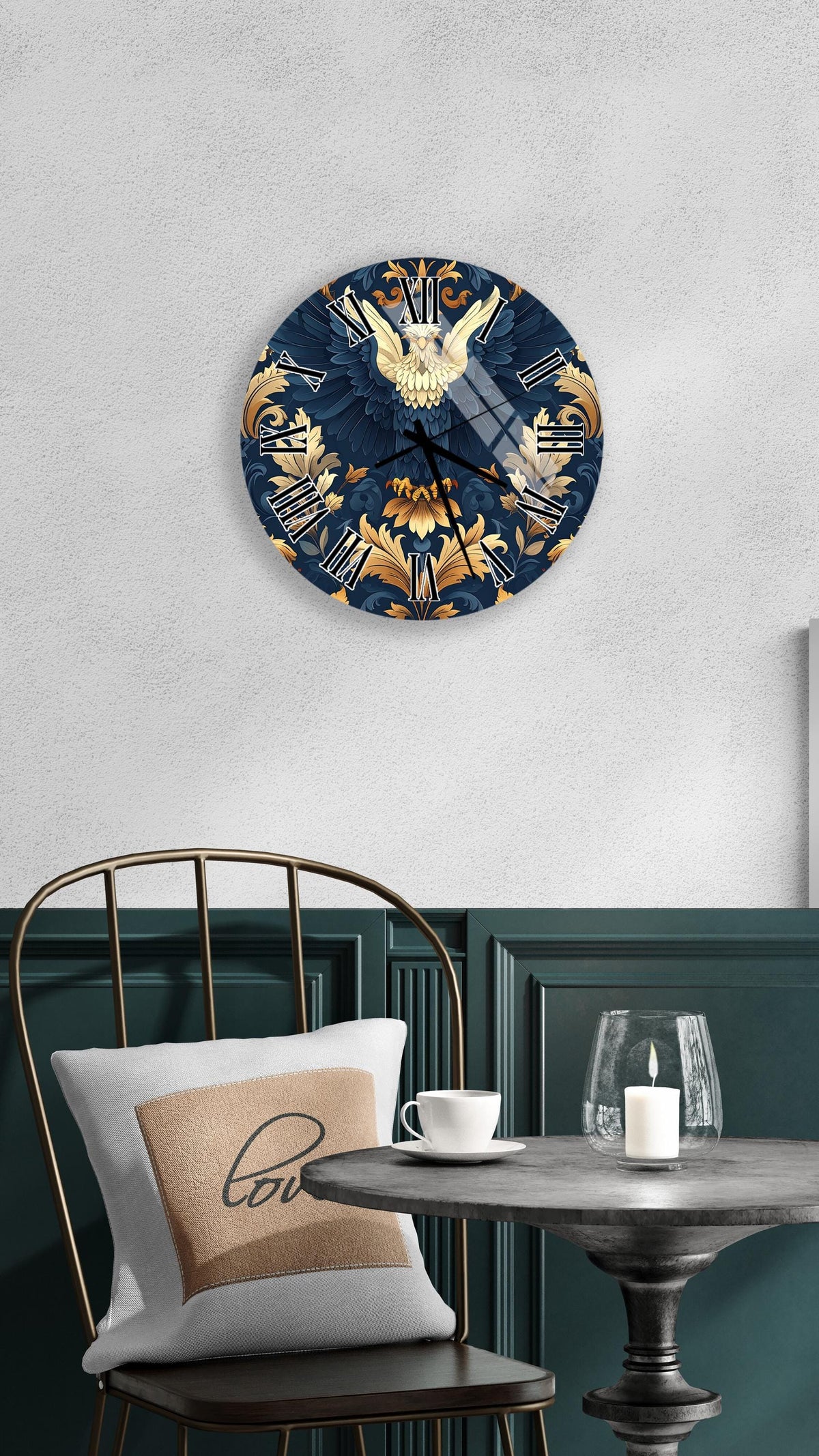 a wall clock with a blue and gold design, mounted on a wall above a dining table with a white tablecloth. The table is set with a white cup and a candle, creating a cozy and elegant atmosphere.