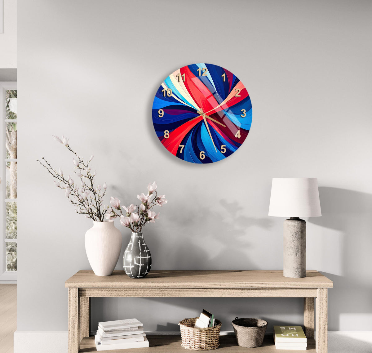 a modern living room with a wooden console table, a white vase with pink flowers, a lamp, and a colorful abstract clock on the wall.