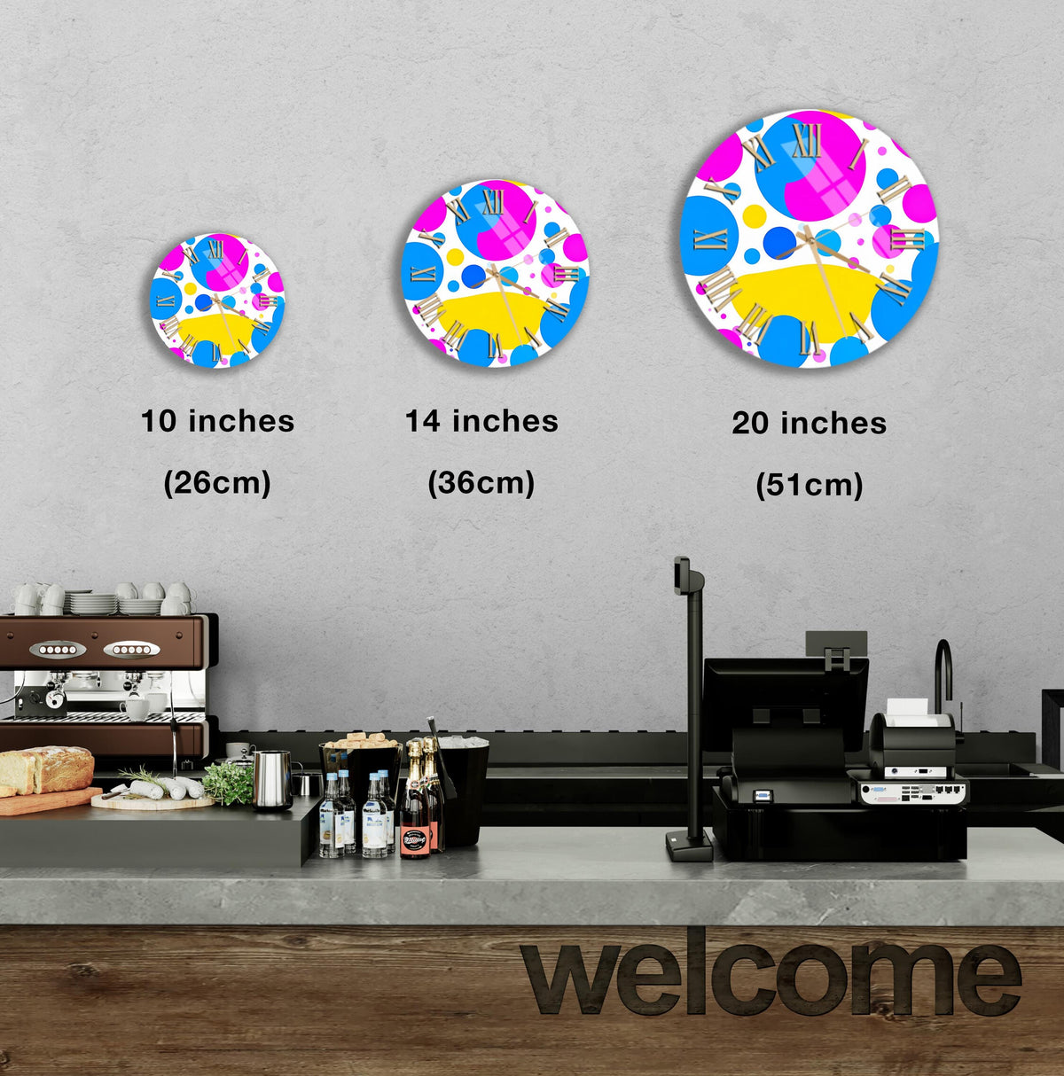 a counter with a cash register, and there are three different sizes of circular wall art displayed above it.