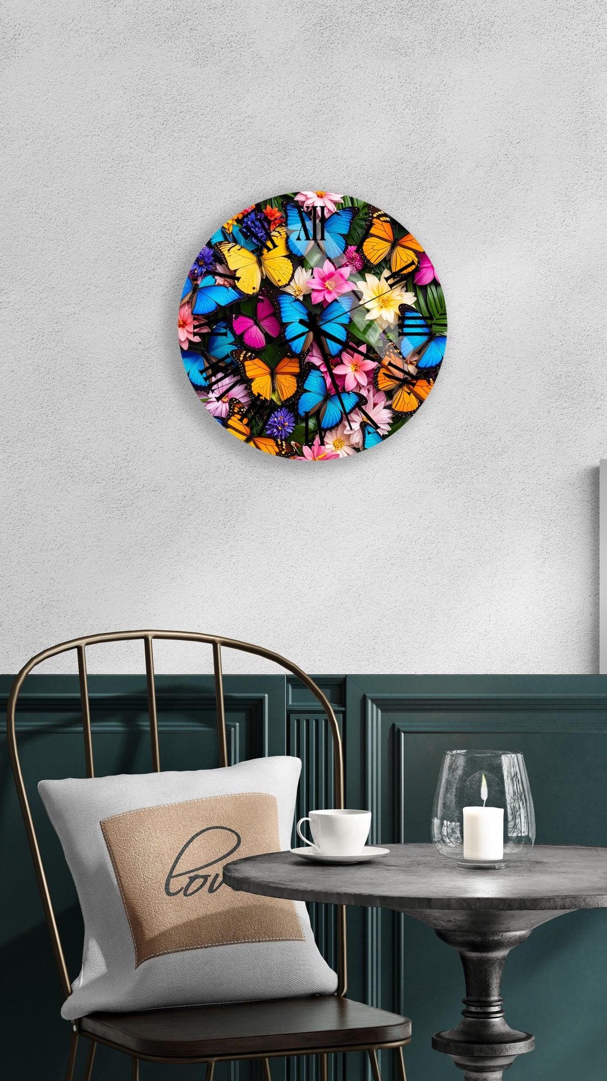 a round wall clock with a vibrant butterfly design, hanging on a white wall above a table with a white tablecloth.