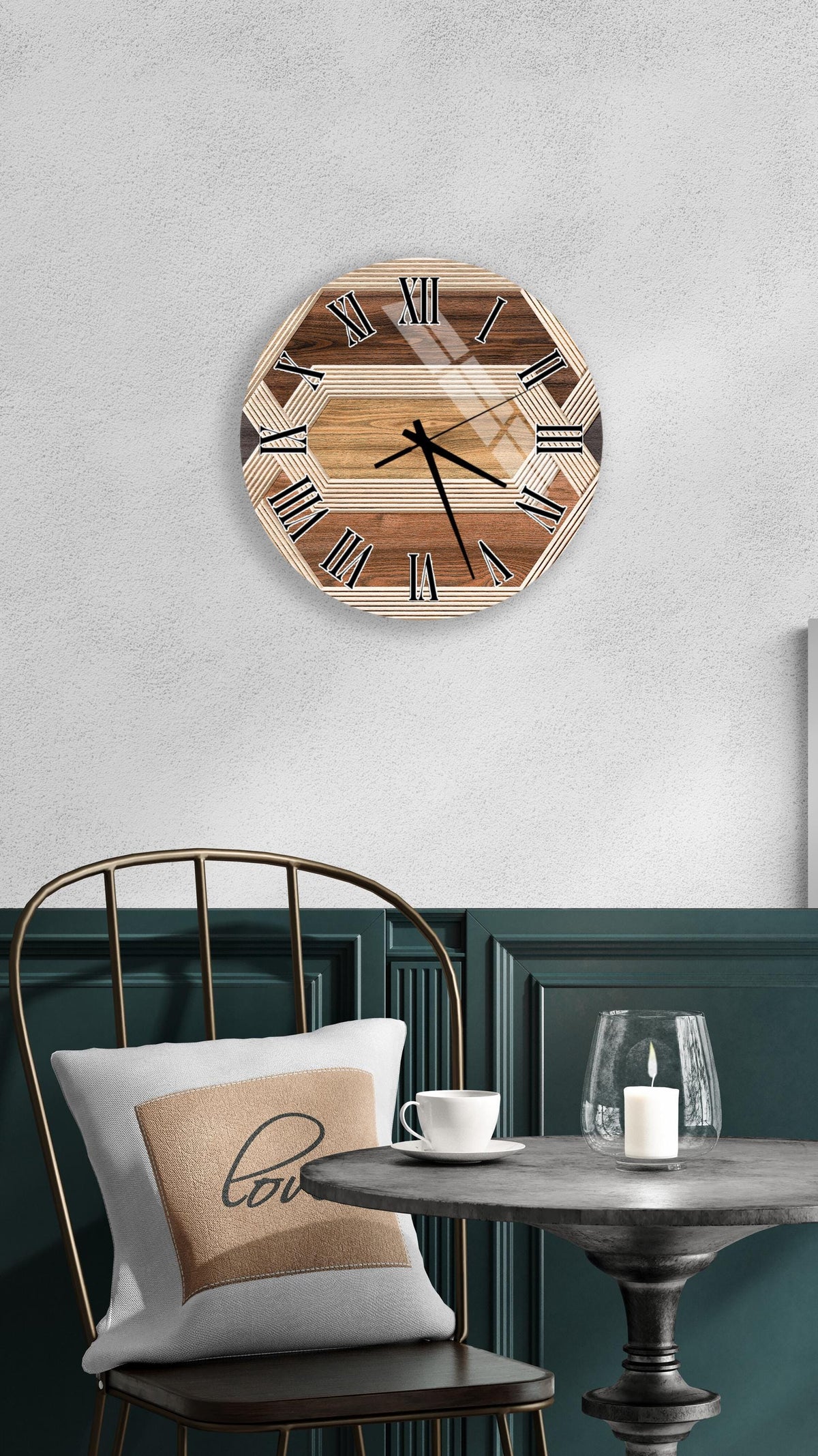 a wooden clock with Roman numerals mounted on a wall above a table with a white tablecloth and a candle.