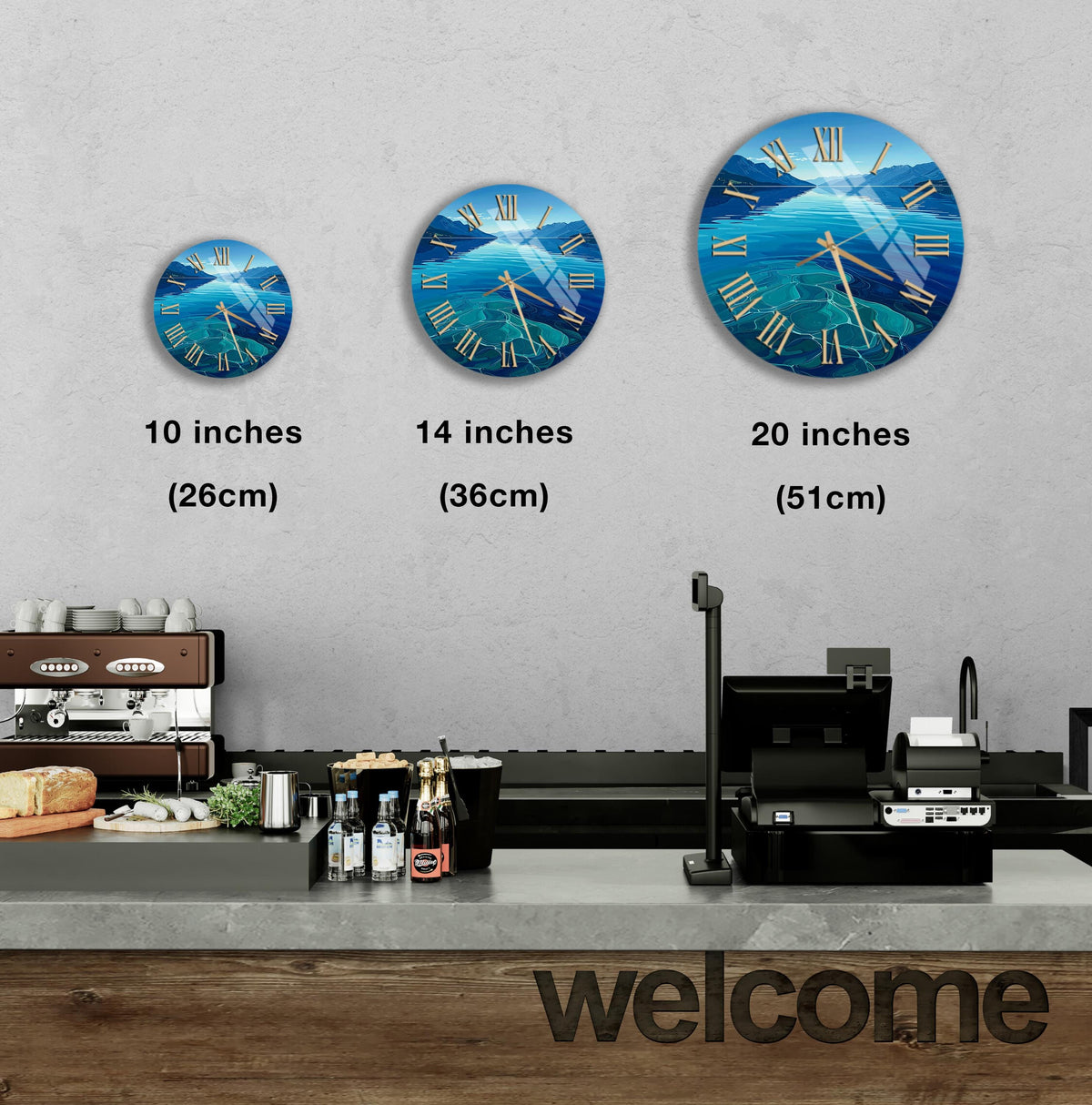 a wall with three clock faces of different sizes, each depicting a blue ocean scene. Below the clock faces, there is a counter with various items such as bottles and a sandwich. The word "welcome" is written on the counter.