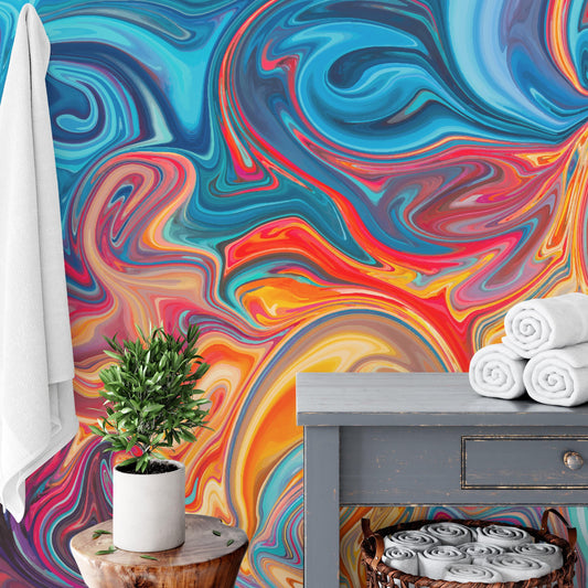 a vibrant, abstract mural with swirling patterns of blue, orange, and red colors. In the foreground, there is a small potted plant on a wooden stool, and a stack of white towels is neatly arranged on a gray table.