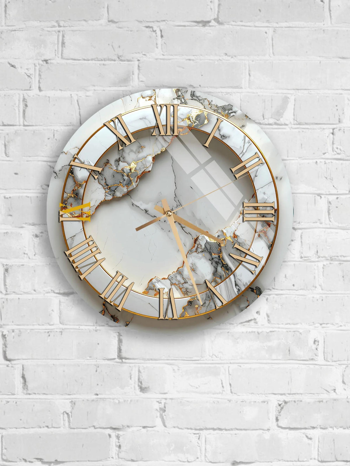 A white marble clock with gold Roman numerals is mounted on a white brick wall.
