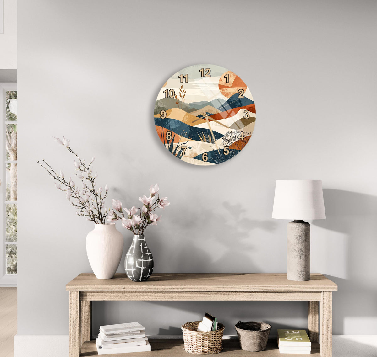 a modern living room with a wooden console table, a round wall clock with a colorful abstract design, a white vase with pink flowers, and a white lamp on a side table.