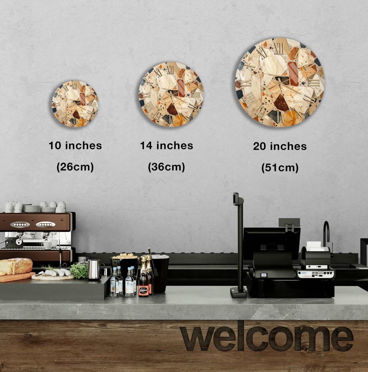 a counter in a restaurant with a "welcome" sign, and three different clock designs displayed on the wall above the counter.