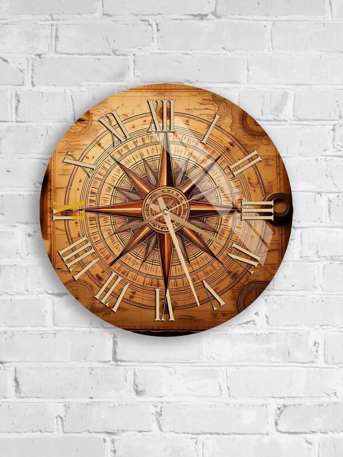 A round wall clock with Roman numerals and a compass rose design, mounted on a white brick wall.