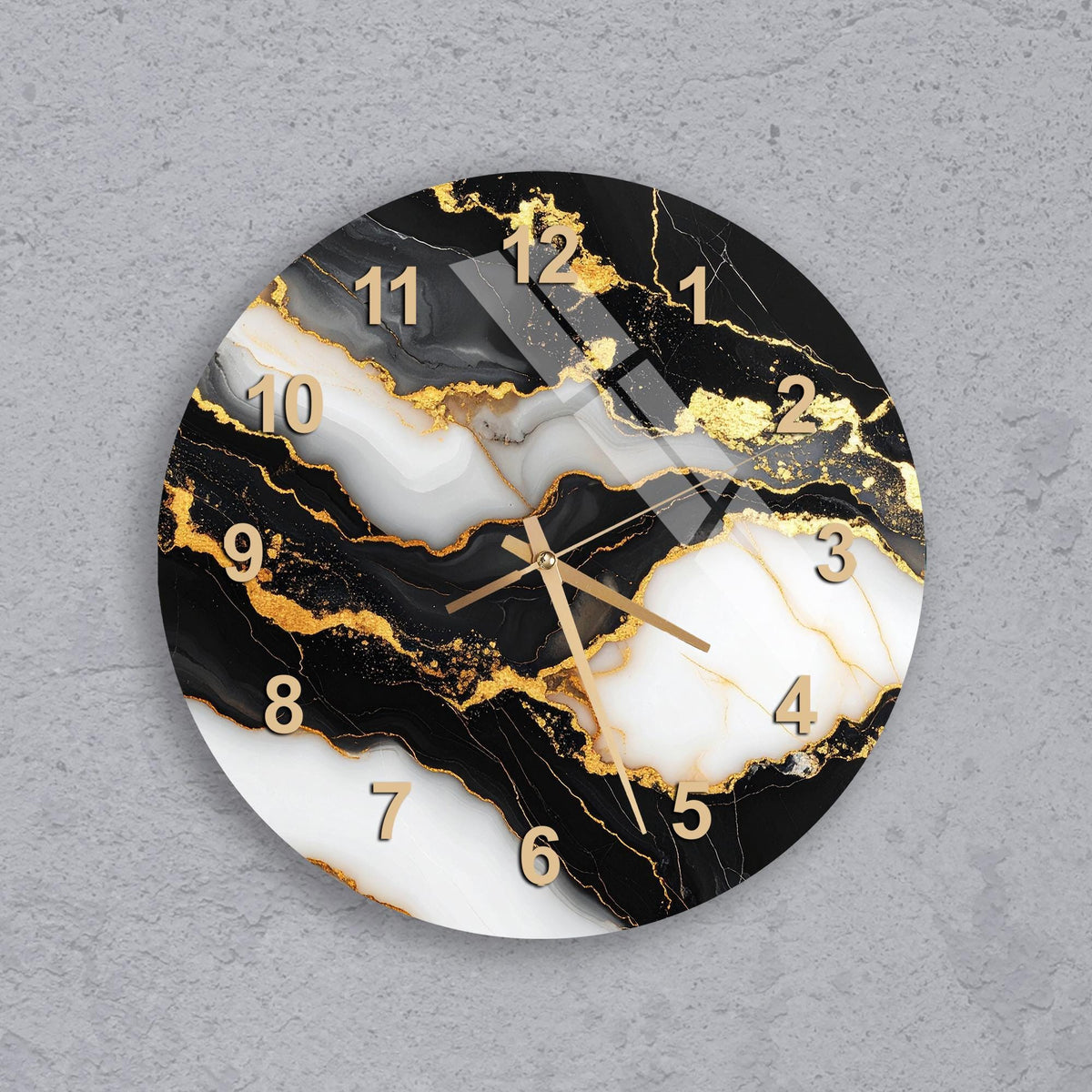 A wall clock with a marble-like design featuring black, white, and gold colors.