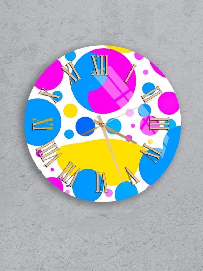 six colorful clocks with various patterns and designs, including polka dots, stripes, and other abstract shapes.