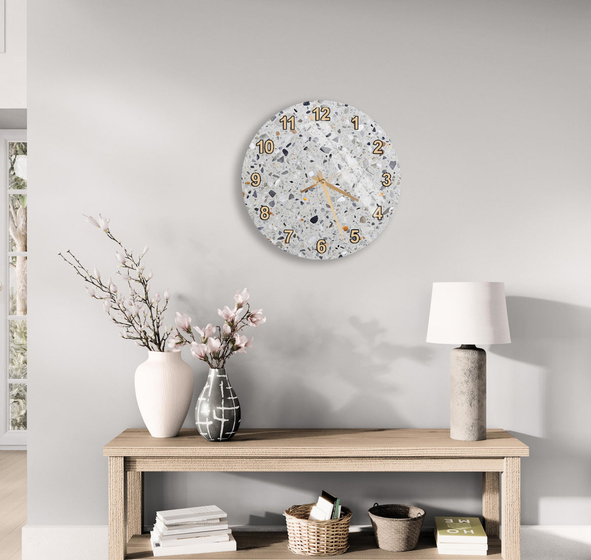 a modern living room with a wooden table, a lamp, a vase with flowers, and a wall clock.