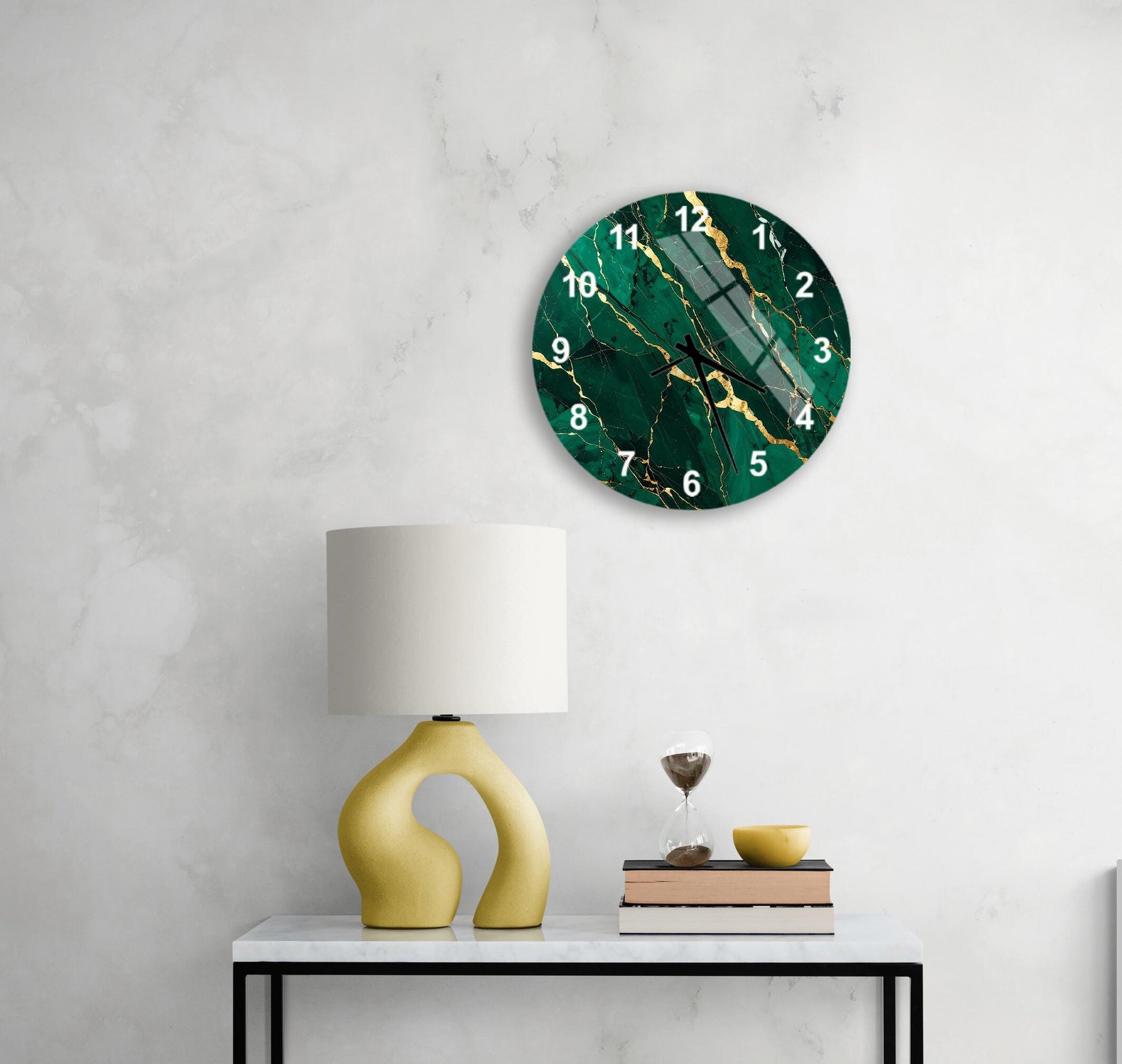 a modern living room with a white marble wall, a round green and gold clock, a yellow lamp, a white table, and a stack of books.