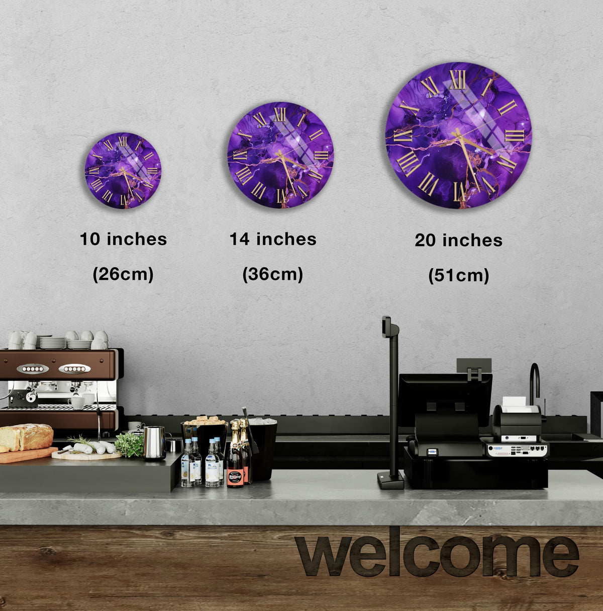 a wall clock with purple and gold designs, and there are three different sizes of the clock displayed on the wall.