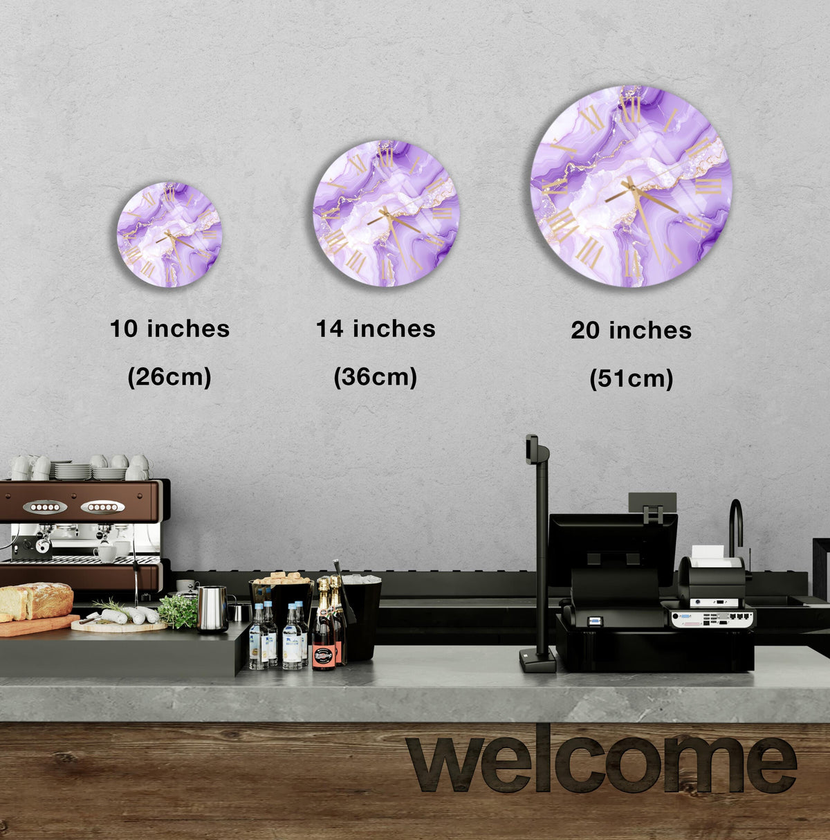 a counter with a cash register, a coffee machine, and various food items such as bottles and bread. Above the counter, there are three clock images of different sizes, each depicting a purple and white design. The image also includes text indicating the sizes of the clock images in inches.