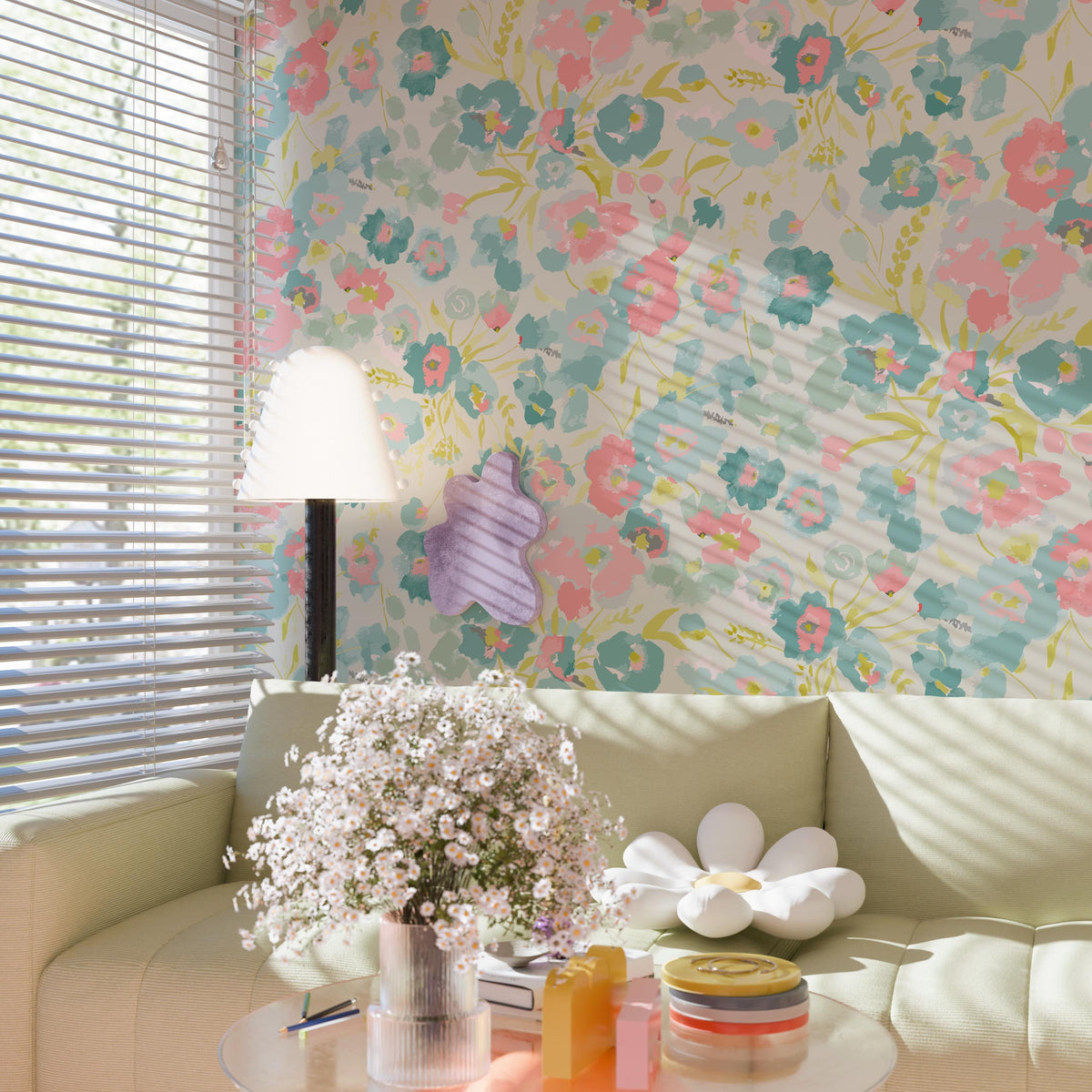 a cozy living room with a floral wallpaper, a white sofa, a table with a vase of white flowers, and a lamp.