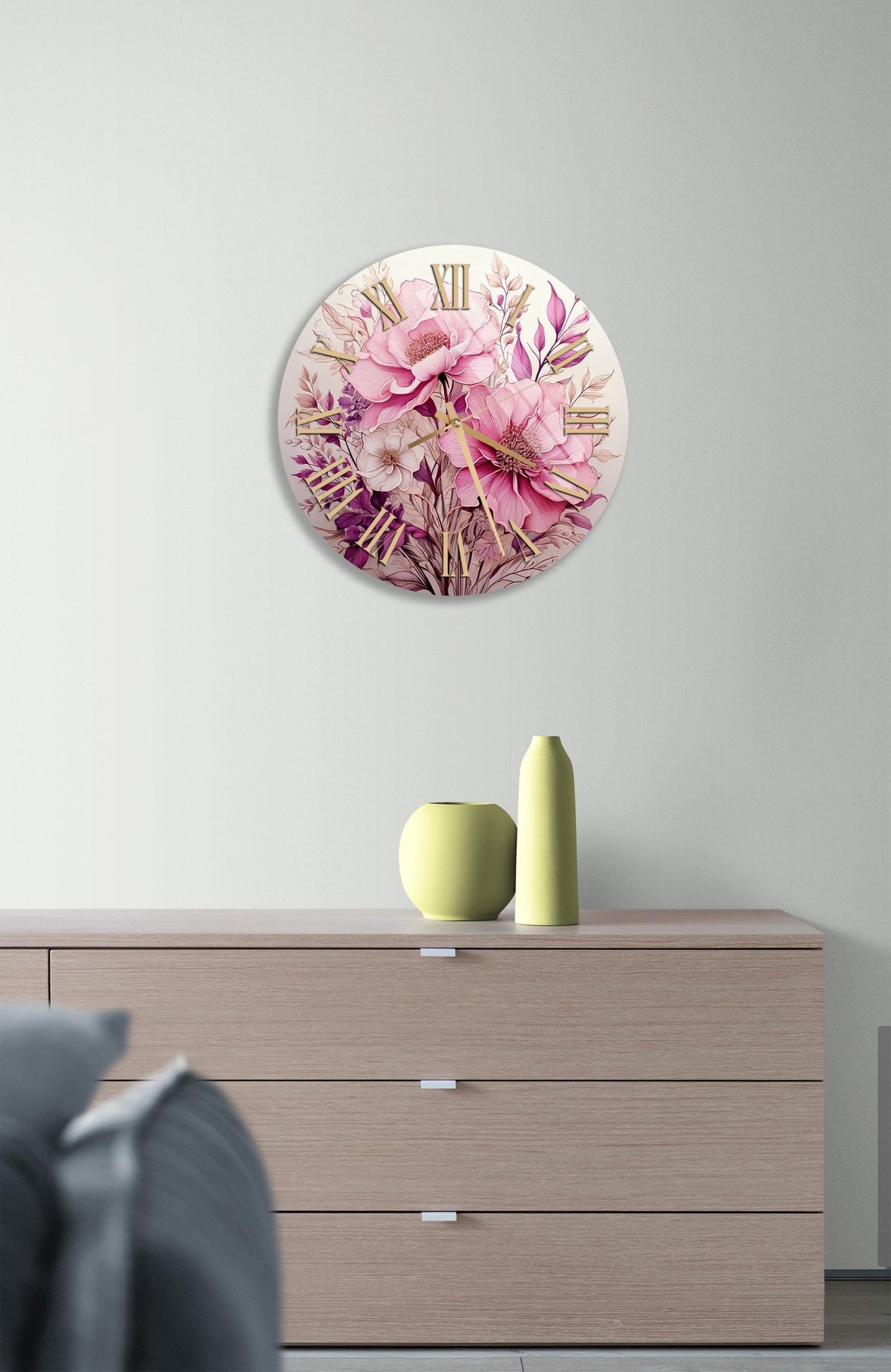 a white clock with pink flowers on it