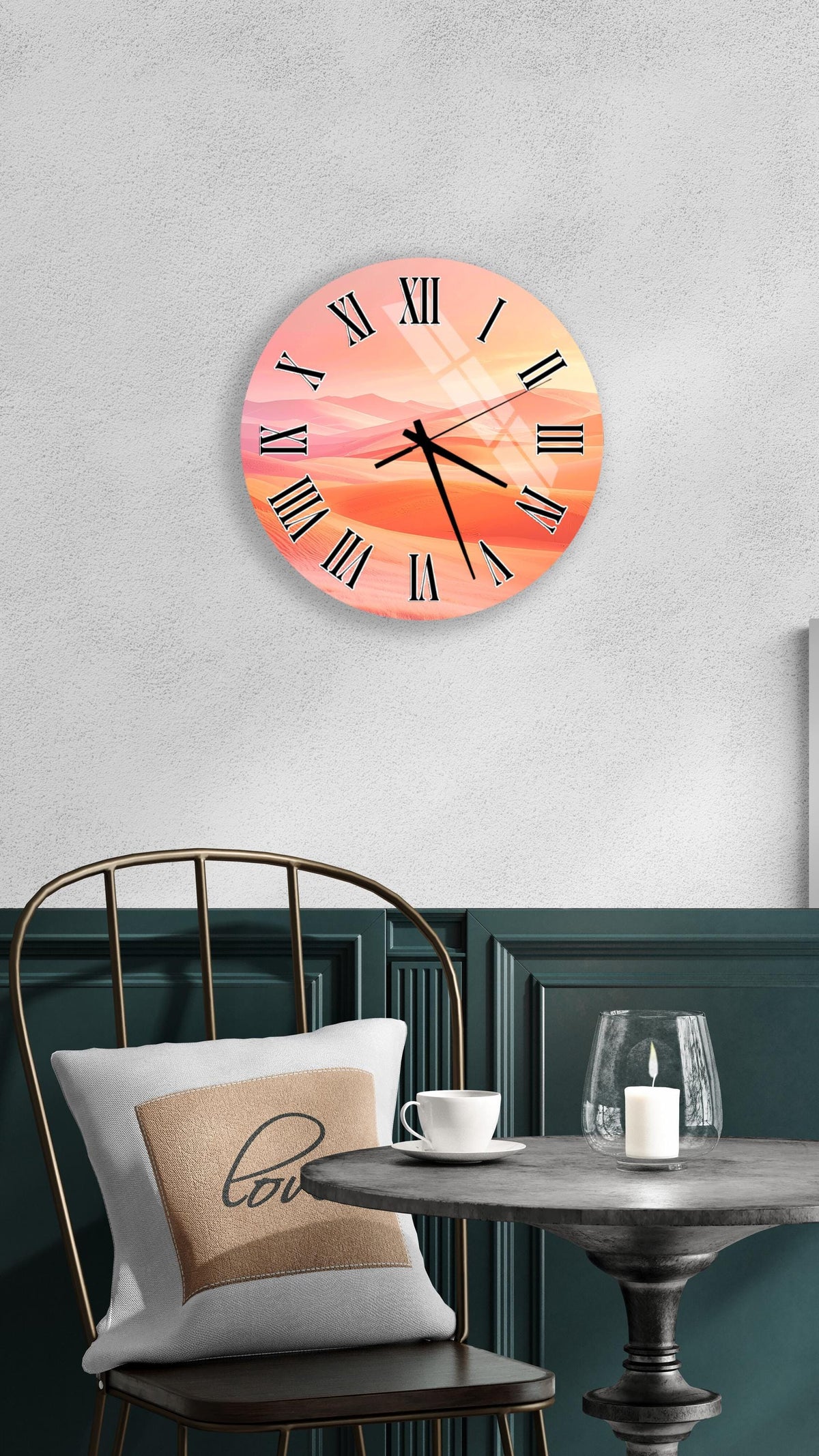 a wall clock with a sunset-like design, mounted on a wall above a table with a white tablecloth and a candle.