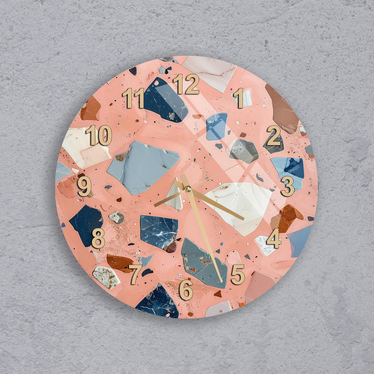 A round wall clock with a unique, colorful design featuring various shapes and textures, including numbers and other decorative elements.