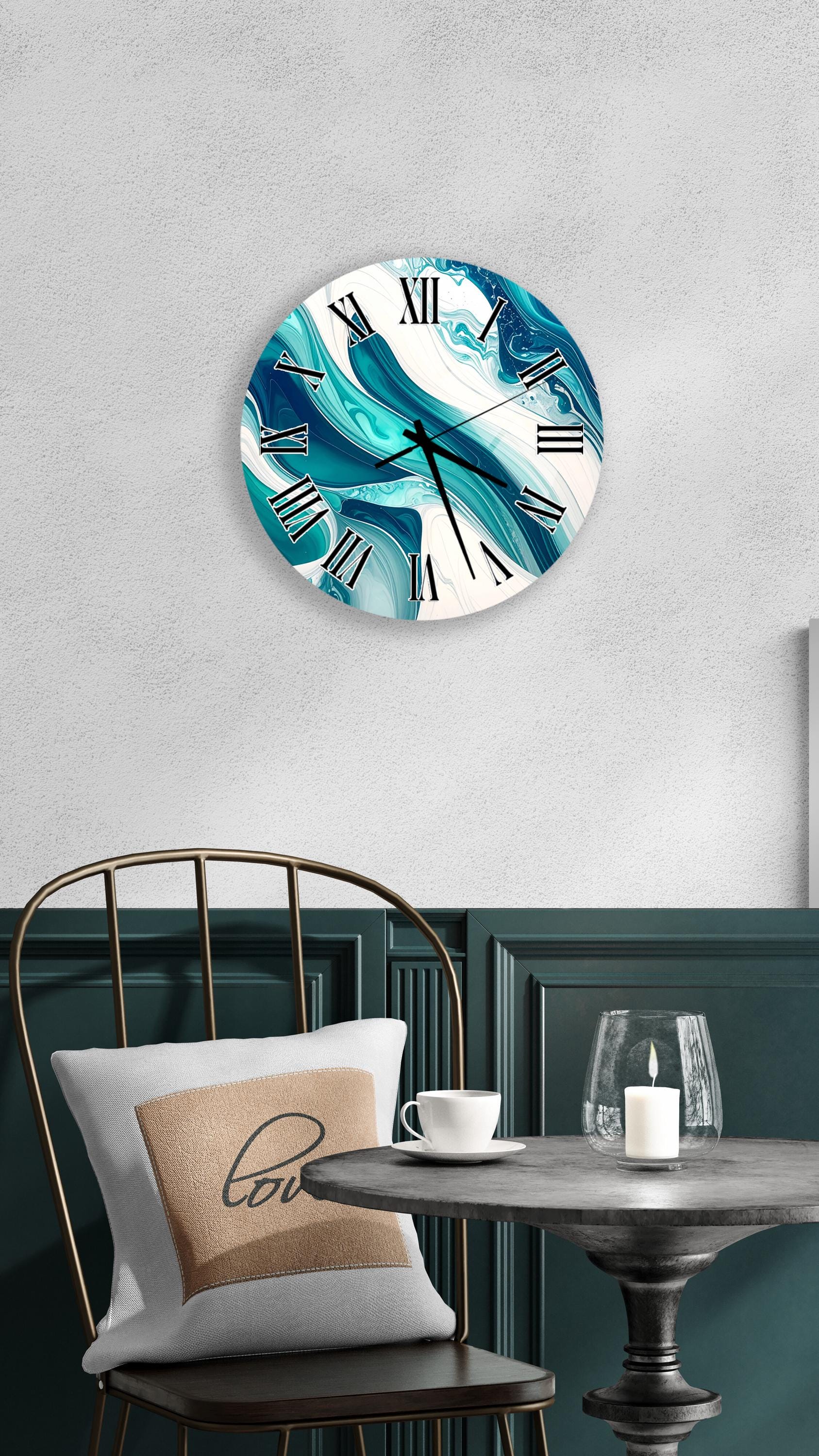 a modern interior design with a round wall clock displaying a blue and white marble pattern, a white table with a candle and a glass, and a black metal chair with a white pillow.