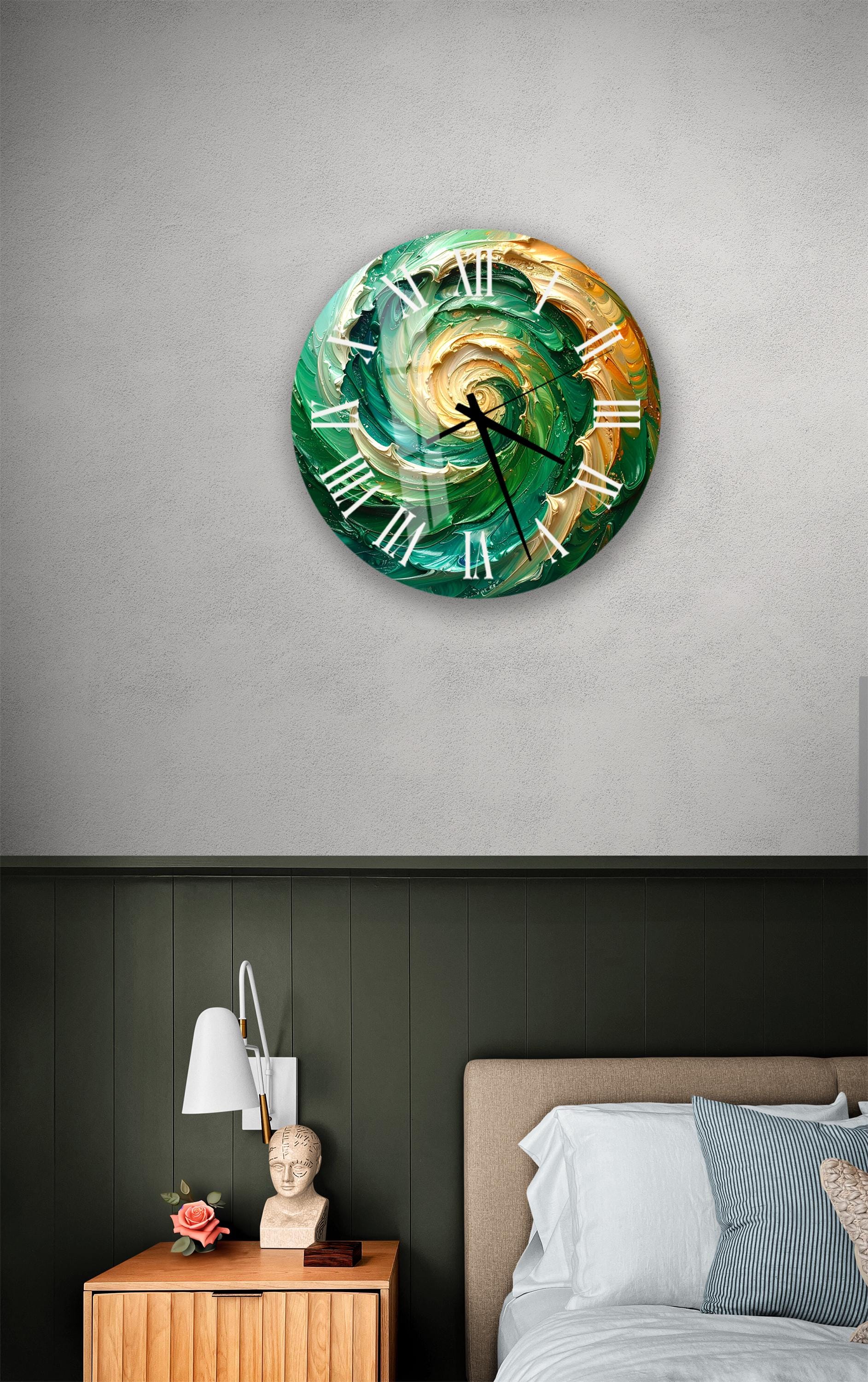 a bedroom setting with a large, colorful, abstract wall clock hanging on the wall above a bed. The clock has a unique design with swirling patterns in shades of green and orange. The room also includes a nightstand with a lamp and a small statue or bust.
