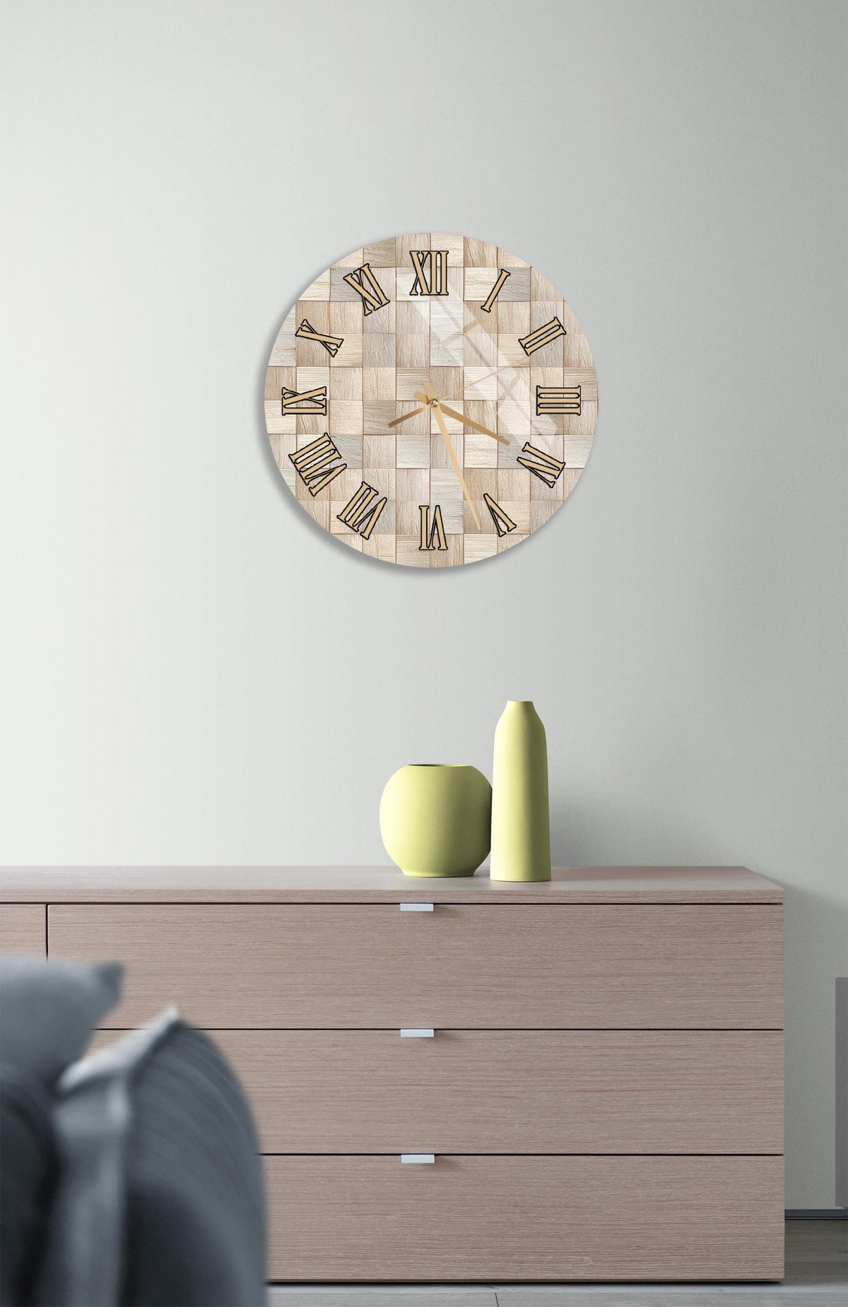 a modern living room with a wooden dresser, a round clock with a mosaic design, and a yellow vase on top of the dresser.