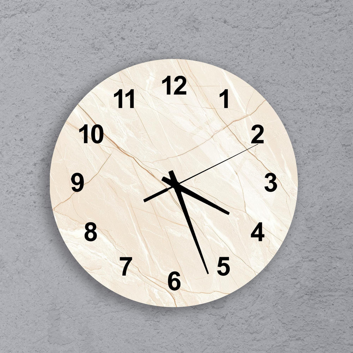 A round wall clock with a marble-like texture and black numbers on a light-colored background.
