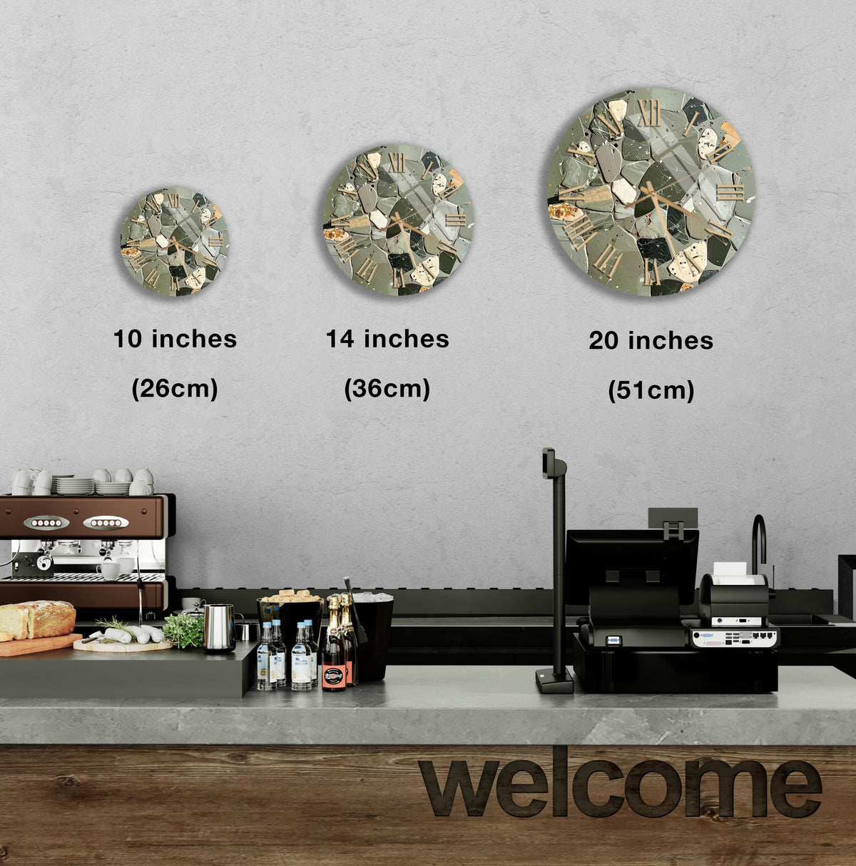 a counter in a restaurant with a "welcome" sign, and three different-sized round clock designs displayed on the wall above the counter.